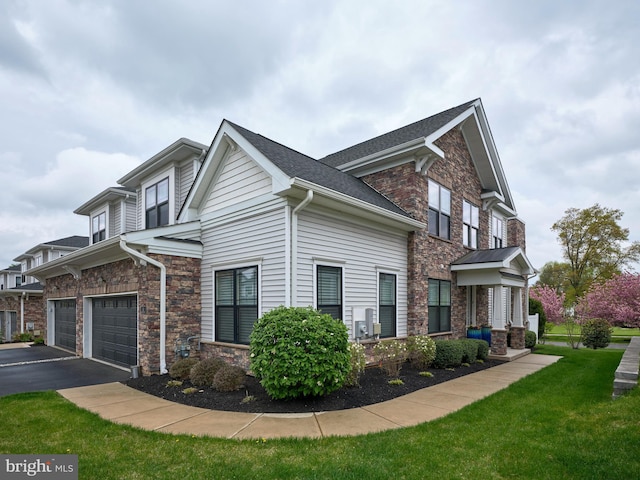 view of property exterior with a yard, driveway, an attached garage, and stone siding