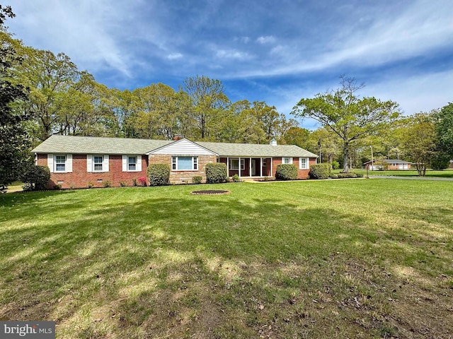 single story home with a chimney, a front lawn, crawl space, and brick siding
