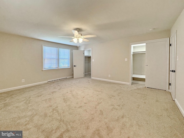 unfurnished bedroom with baseboards, a spacious closet, visible vents, and carpet