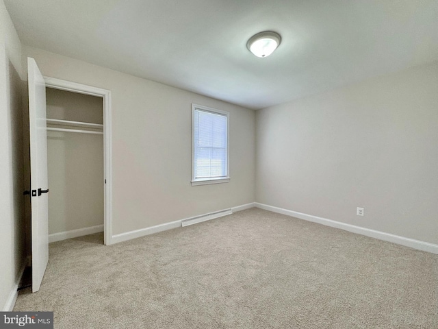 unfurnished bedroom featuring a closet, baseboards, and carpet floors