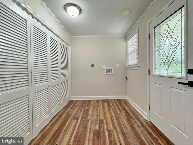 interior space featuring wood finished floors, crown molding, and baseboards