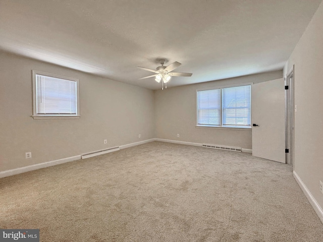 unfurnished room featuring a ceiling fan, visible vents, carpet, and baseboards