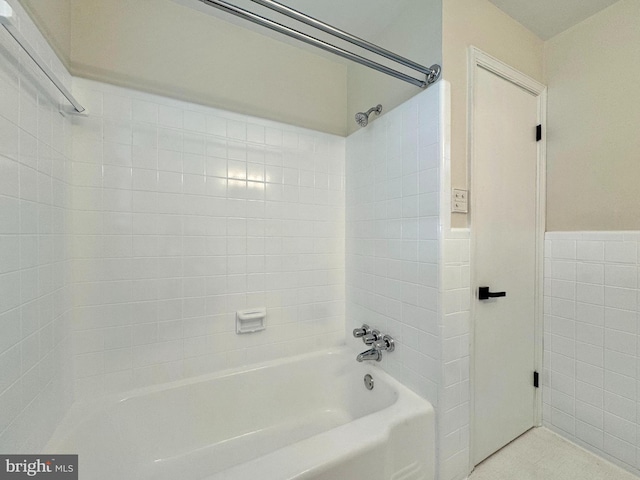full bathroom featuring tile walls and bathtub / shower combination