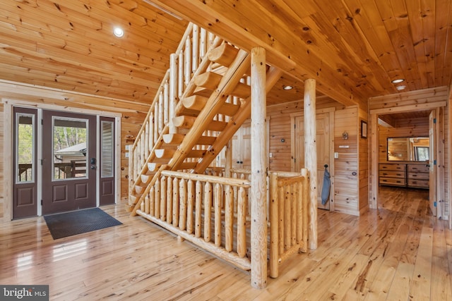 foyer entrance with wood-type flooring, wood walls, wood ceiling, and recessed lighting