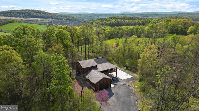 view from above of property with a heavily wooded area