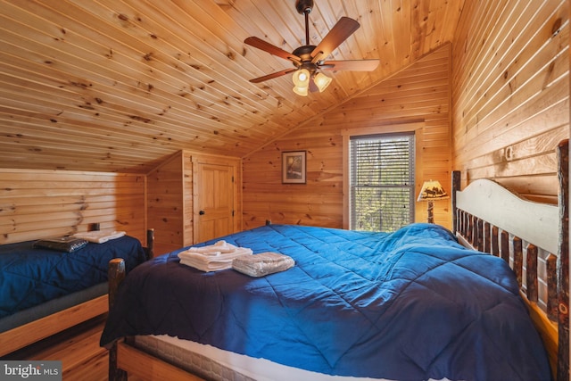 bedroom featuring vaulted ceiling, wooden ceiling, wooden walls, and ceiling fan