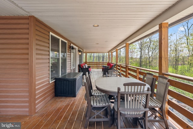 wooden terrace featuring outdoor dining area