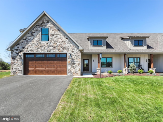 149 Matthew Dr, Chambersburg, PA 17201 - view of front of house featuring a garage, a front lawn, aphalt driveway, stone siding, and roof with shingles