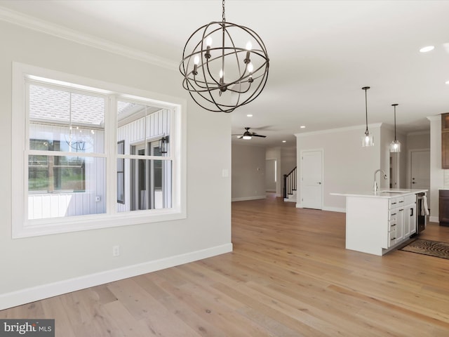 149 Matthew Dr, Chambersburg, PA 17201 - unfurnished dining area featuring crown molding, baseboards, a sink, and light wood-style floors