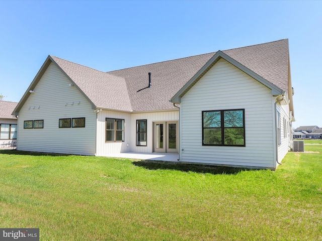 149 Matthew Dr, Chambersburg, PA 17201 - back of property with roof with shingles, board and batten siding, a patio area, central air condition unit, and a lawn