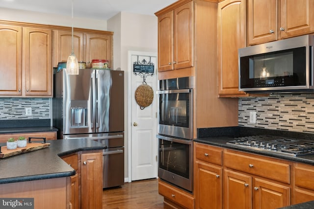 16 Zachary Ct, Boonsboro, MD 21713 - kitchen featuring stainless steel appliances, dark countertops, tasteful backsplash, and dark wood-type flooring
