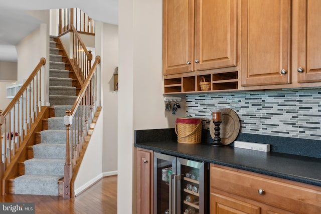 16 Zachary Ct, Boonsboro, MD 21713 - indoor dry bar featuring beverage cooler, decorative backsplash, stairs, wood finished floors, and baseboards