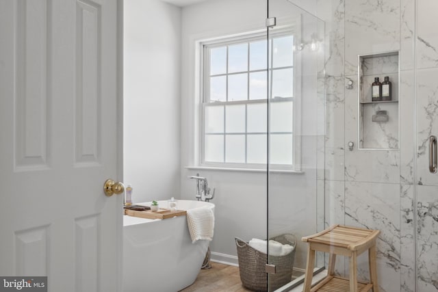 16 Zachary Ct, Boonsboro, MD 21713 - bathroom featuring a marble finish shower, plenty of natural light, a freestanding tub, and wood finished floors