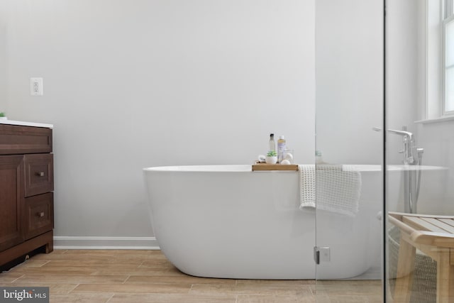 16 Zachary Ct, Boonsboro, MD 21713 - bathroom featuring a soaking tub, vanity, wood tiled floors, and baseboards