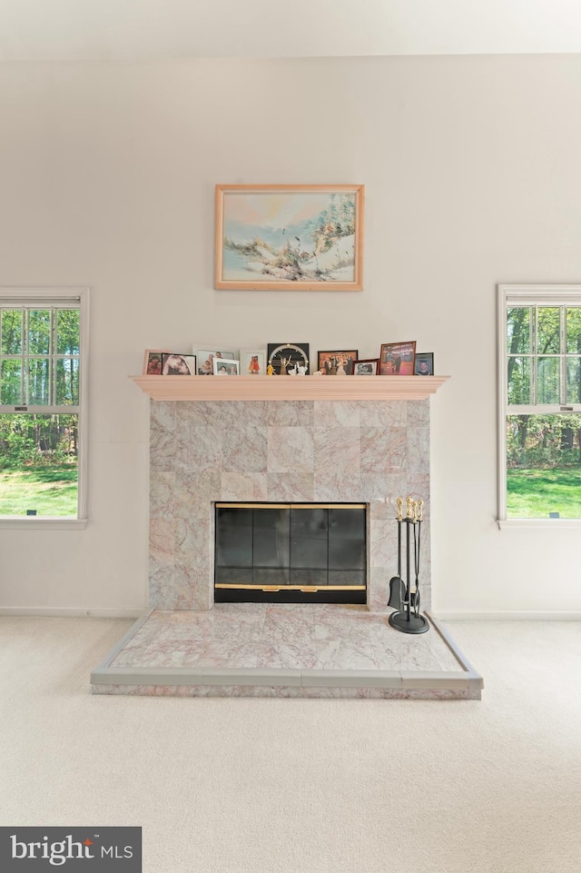 25 Stallion Cir, Upper Holland, PA 19053 - details featuring a glass covered fireplace, carpet flooring, and baseboards