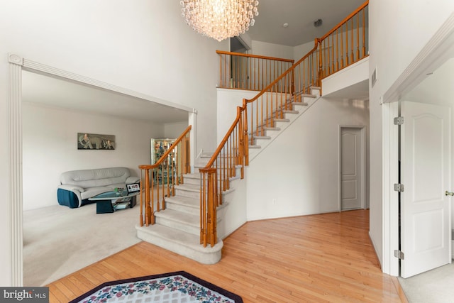 25 Stallion Cir, Upper Holland, PA 19053 - stairs with wood finished floors, a chandelier, visible vents, and a high ceiling