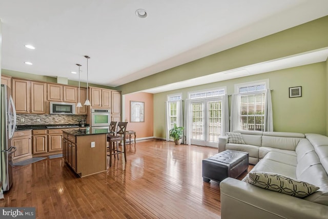 living area with recessed lighting, baseboards, and dark wood-style floors