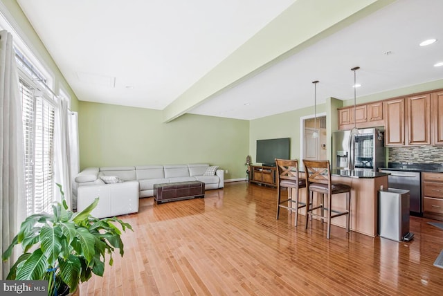 living room with light wood-type flooring and recessed lighting