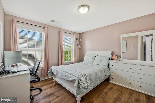 bedroom featuring visible vents and dark wood-type flooring