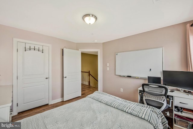 bedroom featuring baseboards and wood finished floors