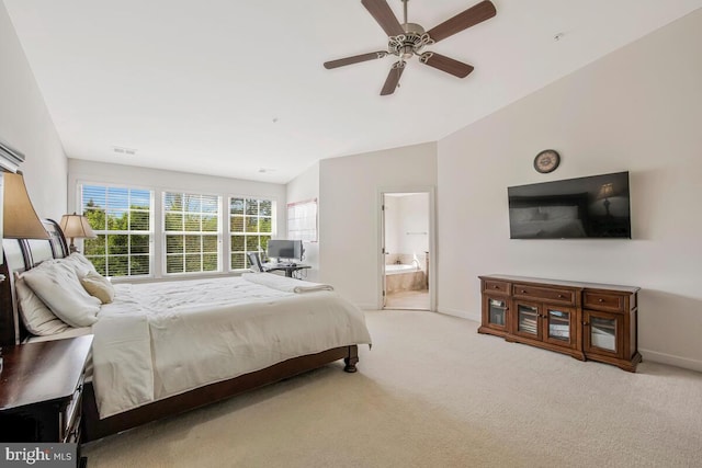 bedroom featuring visible vents, baseboards, ensuite bathroom, carpet flooring, and vaulted ceiling