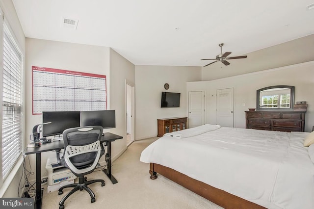 carpeted bedroom featuring visible vents and ceiling fan