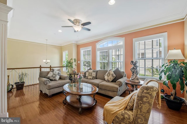 living room featuring wood-type flooring, recessed lighting, crown molding, and ceiling fan with notable chandelier