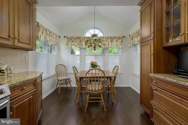 dining room with baseboards, a chandelier, dark wood finished floors, and lofted ceiling