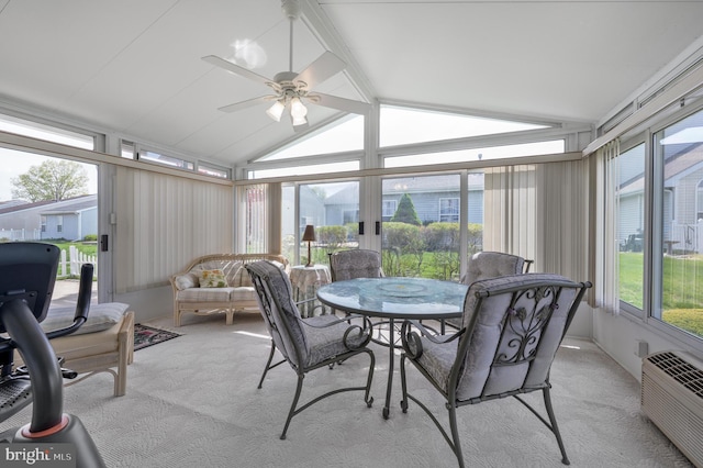 sunroom with carpet flooring, outdoor dining space, ceiling fan, and lofted ceiling