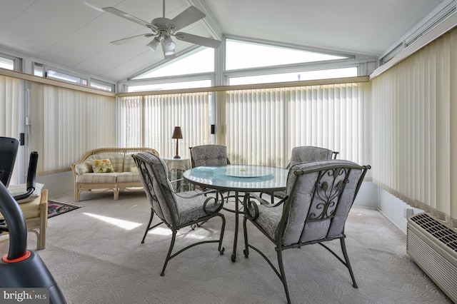 sunroom / solarium featuring a ceiling fan, carpet, and lofted ceiling