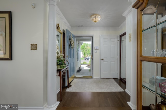 foyer with visible vents, ornamental molding, decorative columns, dark wood-style flooring, and baseboards