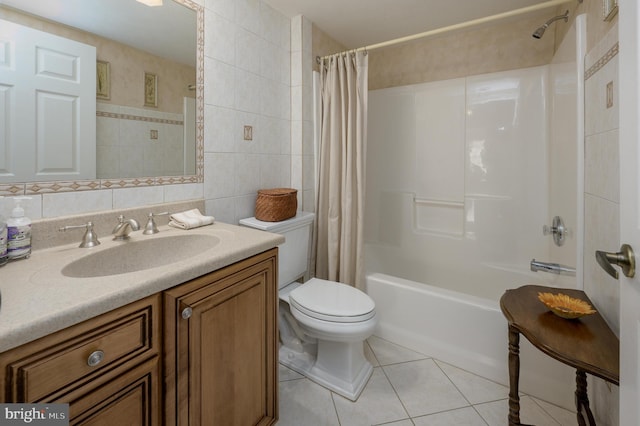 bathroom featuring tile walls, shower / bath combo, vanity, tile patterned floors, and toilet