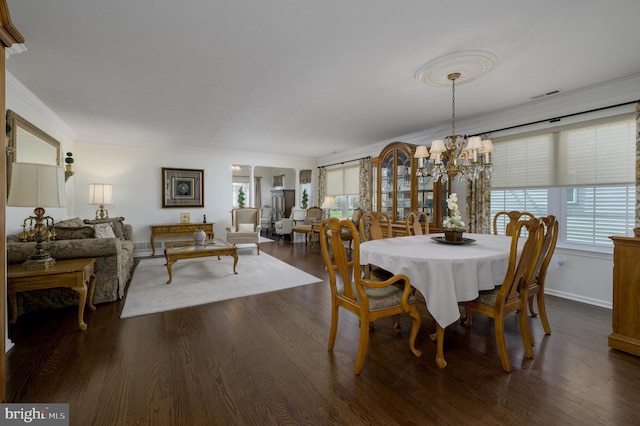 dining space featuring dark wood-style flooring, visible vents, crown molding, baseboards, and a chandelier