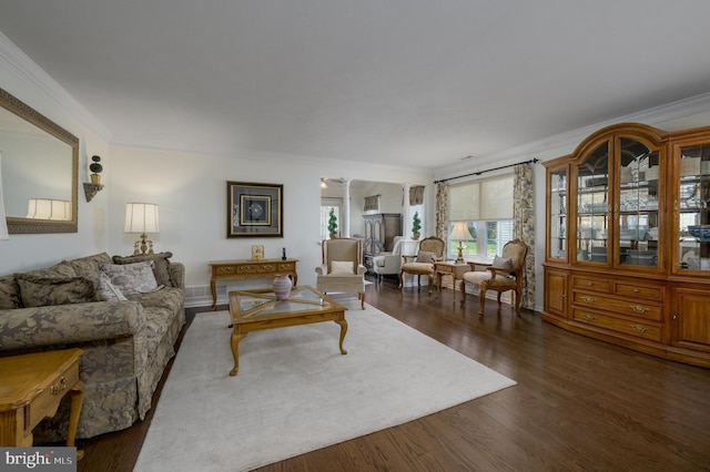 living room featuring ornamental molding and dark wood-style flooring
