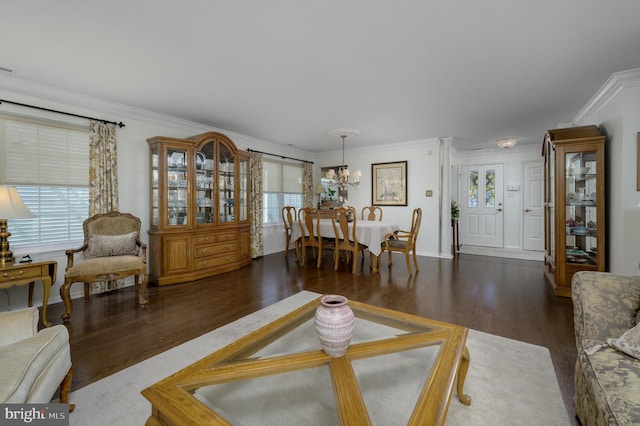 living room with ornamental molding, a wealth of natural light, and wood finished floors