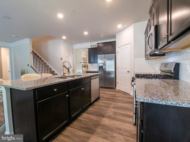 9318 Sydney Way, Laurel, MD 20723 - kitchen with decorative backsplash, a center island with sink, a sink, ornamental molding, and stainless steel appliances