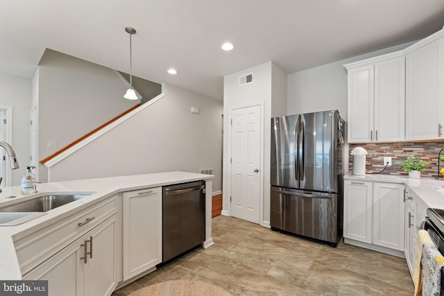 213 Denison St, Fredericksburg, VA 22406 - kitchen with a sink, decorative backsplash, light countertops, white cabinets, and appliances with stainless steel finishes