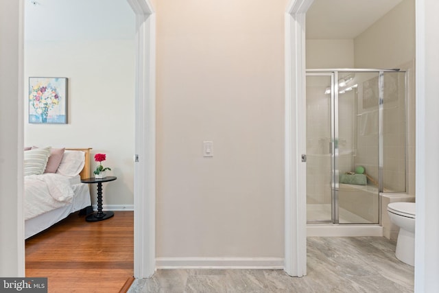 213 Denison St, Fredericksburg, VA 22406 - bathroom with toilet, a shower stall, wood finished floors, and baseboards