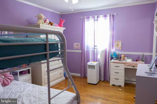 bedroom with light wood-type flooring and ornamental molding