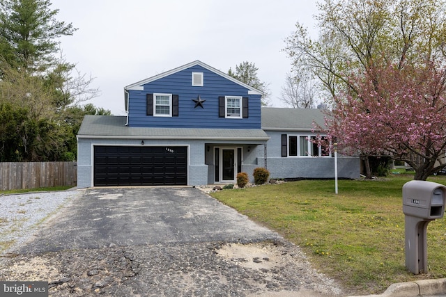 view of front of home featuring aphalt driveway, roof with shingles, a front yard, fence, and brick siding