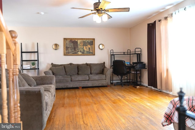 living area featuring light wood-style floors and ceiling fan