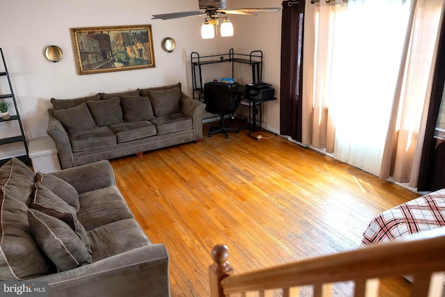 living area with a healthy amount of sunlight, a ceiling fan, and light wood finished floors