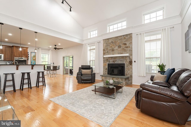 189 Potomac Crossing St, Charles Town, WV 25414 - living room with a ceiling fan, high vaulted ceiling, light wood-style floors, and a fireplace