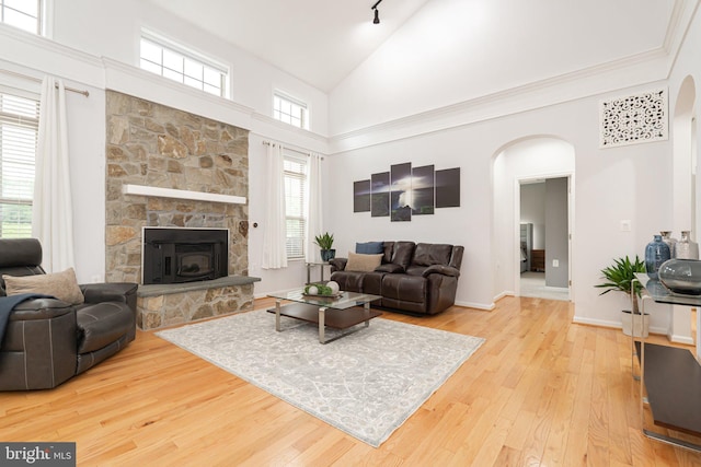 189 Potomac Crossing St, Charles Town, WV 25414 - living room with arched walkways, high vaulted ceiling, hardwood / wood-style floors, a fireplace, and baseboards