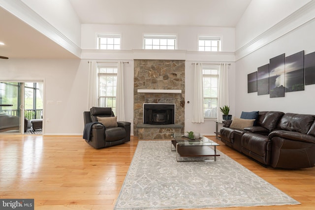189 Potomac Crossing St, Charles Town, WV 25414 - living room featuring light wood-style flooring, a fireplace, and a towering ceiling