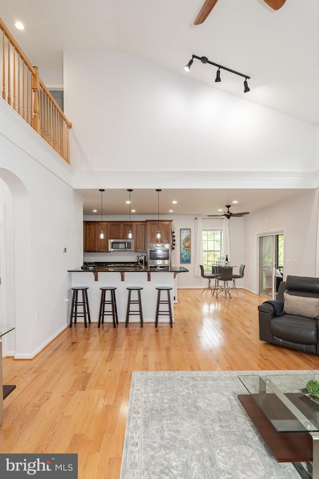 189 Potomac Crossing St, Charles Town, WV 25414 - living room with ceiling fan, arched walkways, high vaulted ceiling, light wood-style floors, and recessed lighting