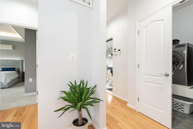 189 Potomac Crossing St, Charles Town, WV 25414 - hall featuring a wall mounted AC, light wood-type flooring, washer / dryer, and baseboards