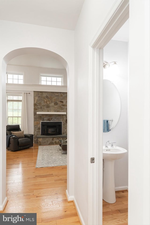 189 Potomac Crossing St, Charles Town, WV 25414 - hallway with wood finished floors, arched walkways, baseboards, and a sink