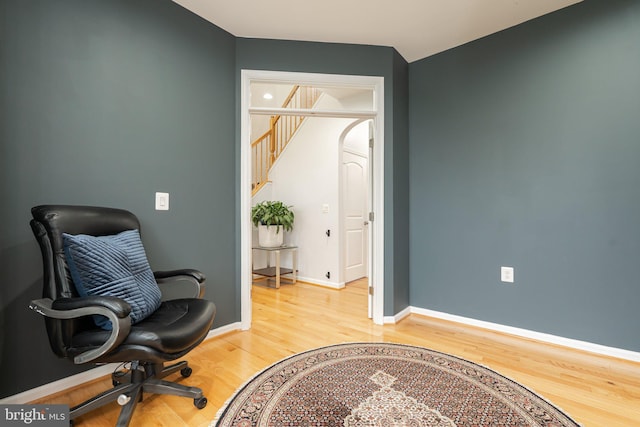 189 Potomac Crossing St, Charles Town, WV 25414 - living area featuring light wood finished floors, arched walkways, stairway, and baseboards