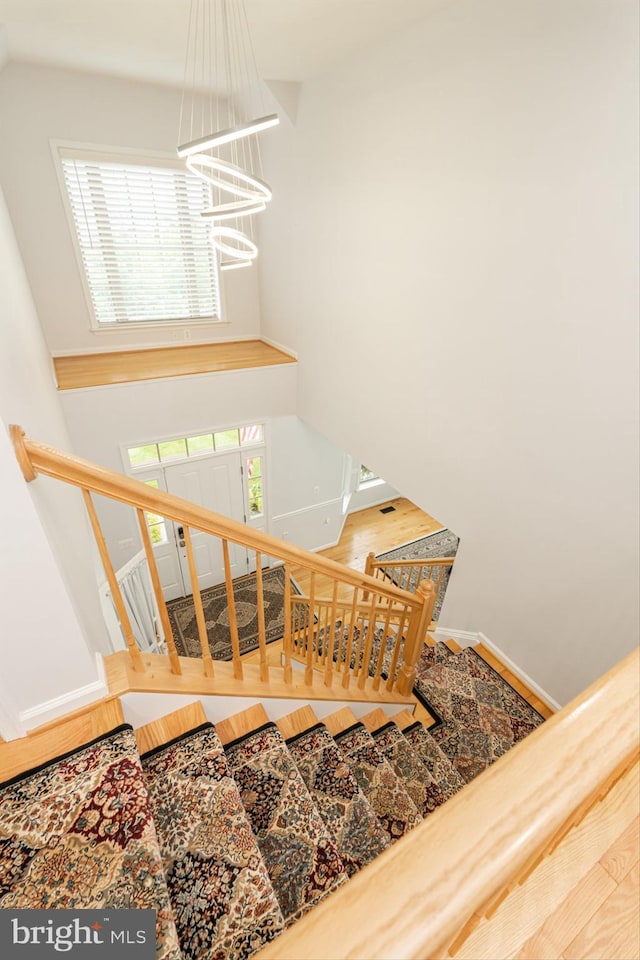 189 Potomac Crossing St, Charles Town, WV 25414 - staircase with a chandelier and baseboards